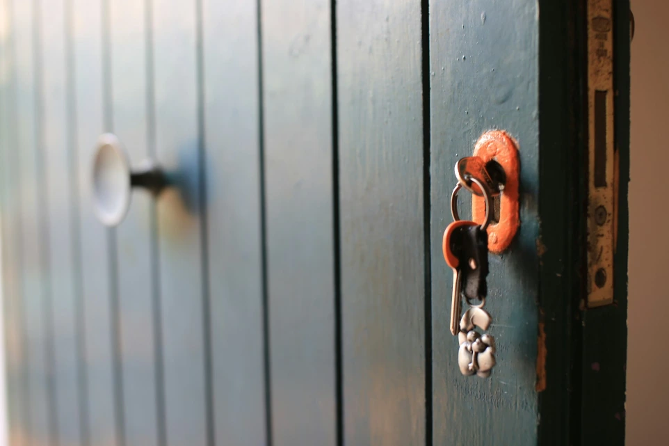 a close up of a door with a bunch of keys on it